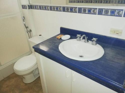 a bathroom with a sink and a toilet at Punta Barandua Beach Department in Santa Elena