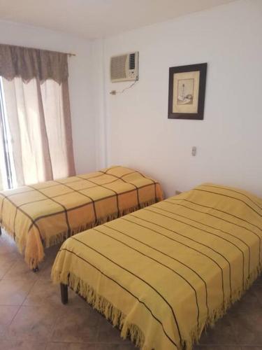 two beds sitting next to each other in a room at Punta Barandua Beach Department in Santa Elena