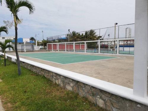 a tennis court in front of a building at Punta Barandua Beach Department in Santa Elena