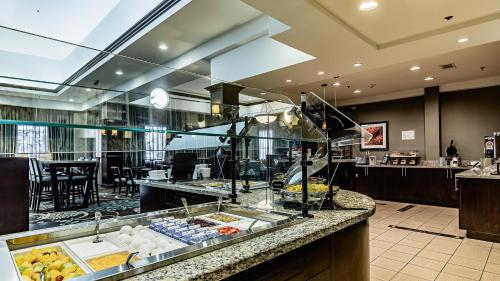 a restaurant with a buffet line with food on display at Staybridge Suites Laredo by IHG in Laredo