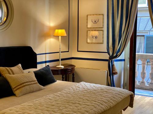 a bedroom with a bed and a lamp and a window at Residenza dei Pucci in Florence