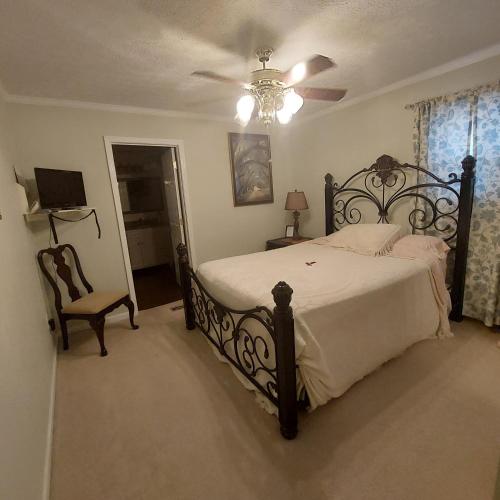 a bedroom with a bed and a ceiling fan at Serenityhill bed and breakfast in Brownsville