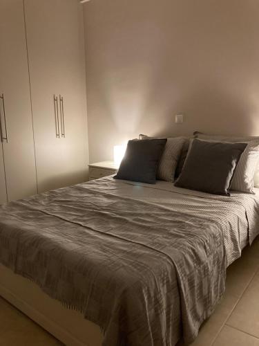 a bedroom with a large bed with two pillows at Bijou Kalamakiou (Athens Riviera) in Athens