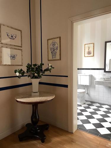 a bathroom with a table with a vase on it at Residenza dei Pucci in Florence