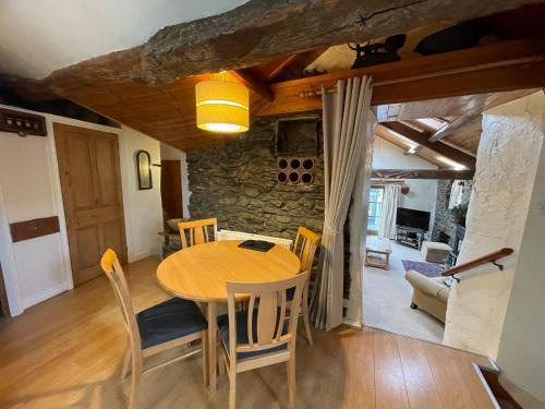a dining room with a wooden table and chairs at Bakestones - Central Location with Free Integral Private Parking in Ambleside