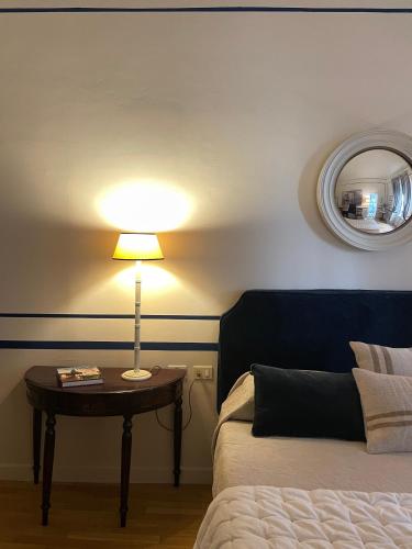 a bedroom with a bed and a table with a lamp at Residenza dei Pucci in Florence