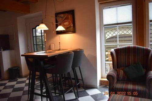 a kitchen with a table and chairs and a window at Gemütliches Landhaus in ruhiger Lage. in Moringen