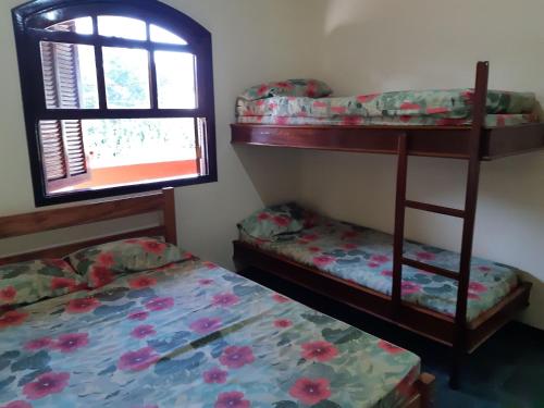- une chambre avec 2 lits superposés et une fenêtre dans l'établissement 0001.08 - Maranduba - Apto - 2 Dormitório - 8 Pessoas - 2 Quadras Do Mar - Piscina - Wi-Fi (Excursão 96 Pessoas), à Ubatuba