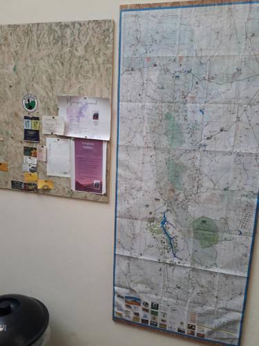 a map hanging on a wall next to a wall at Pousada Pico Da Vila in Vale do Capao