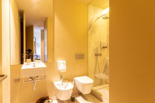 a bathroom with a toilet and a sink and a shower at Prime Lisbon - Dom Luis I in Lisbon