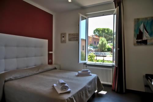 a bedroom with a bed and a large window at Villino Wanda in Monterosso al Mare