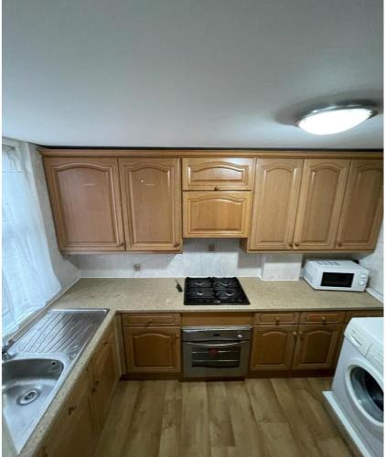 a kitchen with wooden cabinets and a stove top oven at 41 Tanners Endlane in Edmonton