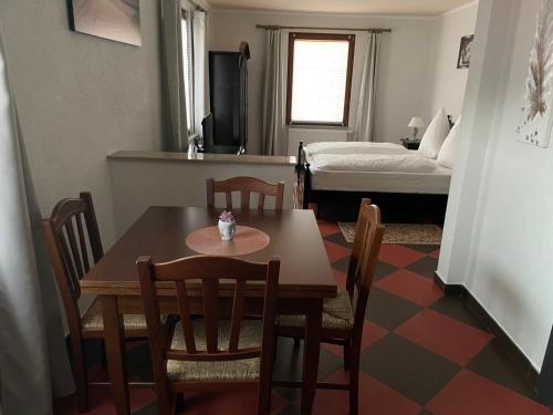 a dining room with a table and chairs and a bedroom at Hotel Roma in Kehl am Rhein