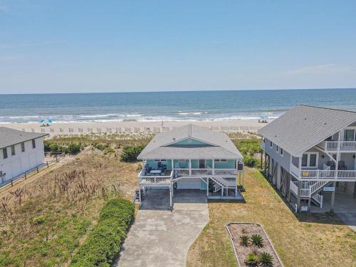 an aerial view of a house and the beach at Salty Paradise home in Holden Beach