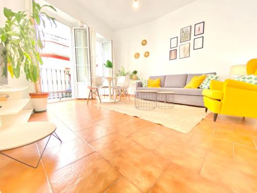 a living room with a couch and a table at Comfortable studio old town, parking optional in Seville