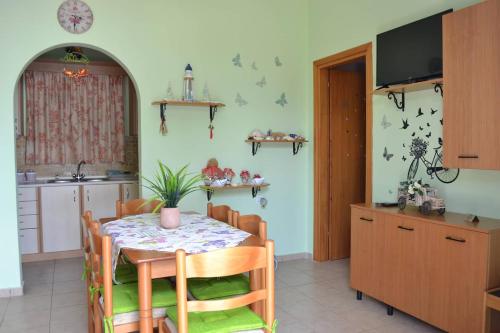 a kitchen and dining room with a table and chairs at GALINI STEGNA BEACH in Archangelos