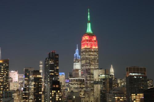a view of the empire state building lit up at night at Hyatt Place New York Chelsea in New York