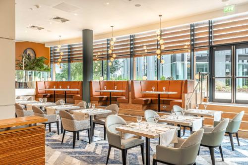 a restaurant with tables and chairs and windows at Crowne Plaza Reading in Reading