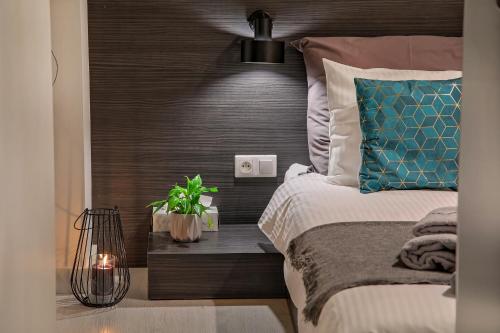 a bedroom with a bed with a wooden headboard at Apartamenty Jagiełły in Łódź
