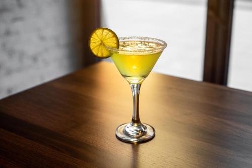 a drink in a glass sitting on a wooden table at Hyatt Place New York Chelsea in New York