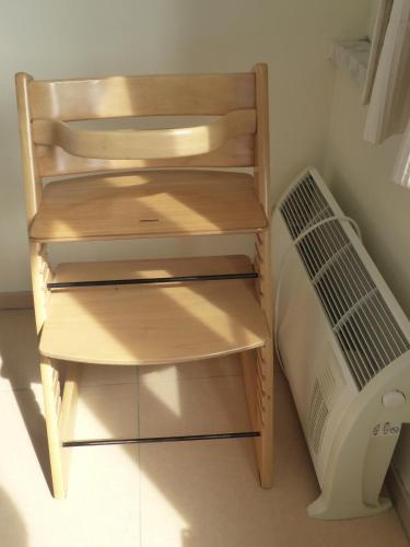 a small wooden shelf next to a bed in a room at Rapallo in Middelkerke