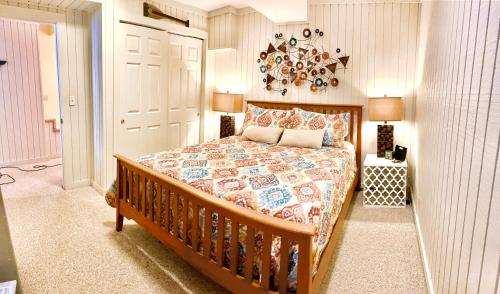 a bedroom with a large bed with a wooden frame at Lake Home by Nashville- Hot tub, swim, fish in Hendersonville