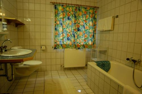 a bathroom with a tub and a sink and a shower curtain at Haus Acherkogel in Tumpen