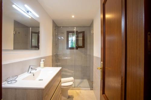 a bathroom with a sink and a toilet and a mirror at OLIVAR de S’HERETAT Trekking/ruta GR-221 (ETV/2099) in Sóller