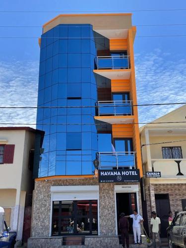 a tall building with people standing in front of it at Havana Hôtel in Morondava