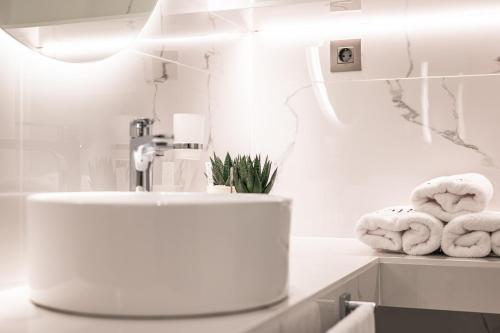 a bathroom with a sink and towels on a counter at Silo Luxury Rooms in Nafplio