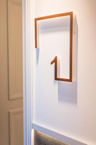 a door with a number one on the wall at Silo Luxury Rooms in Nafplio