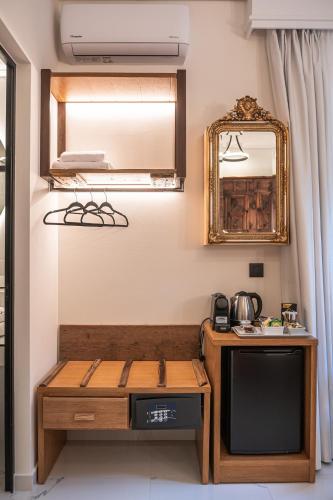 a living room with a couch and a mirror at Silo Luxury Rooms in Nafplio