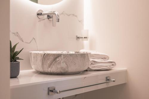 a bathroom with a large bowl sink on a counter at Silo Luxury Rooms in Nafplio