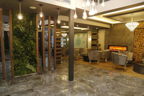 a dining room with chairs and a fireplace at Grand Zara Hotel in Kayseri