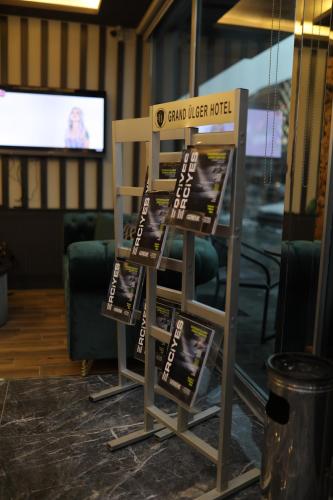 a stand with signs in a room with a tv at Grand Zara Hotel in Kayseri