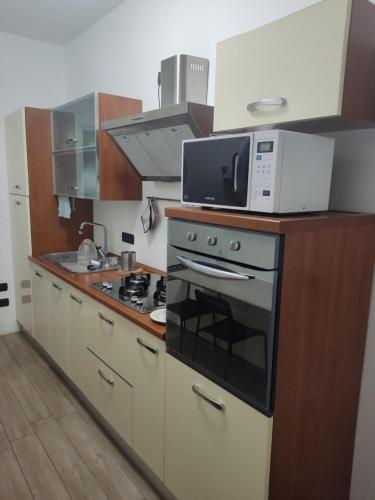 a kitchen with a microwave on top of a stove at Staurenghi34apartmenT in Varese