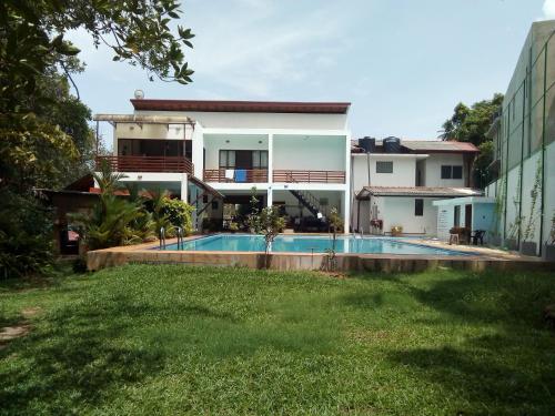 a view of a house with a swimming pool at THE Mangrove cave Hotel in Balapitiya
