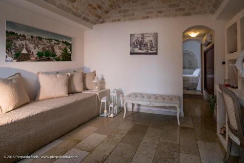 a living room with a couch and a table at Masseria Cappuccini in Ostuni