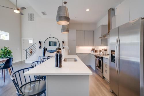 a kitchen with white cabinets and a refrigerator at Mason Lofts at West End in Nashville