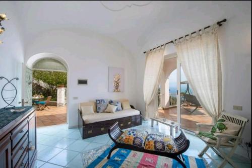a living room with a couch and a table at Villa SEASIDE in Praiano