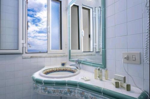 a bathroom with a sink and a mirror at Villa SEASIDE in Praiano