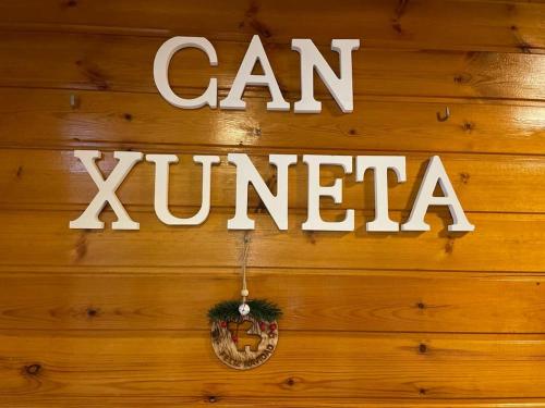 a sign that says can xylan on a wooden wall at Can Xuneta in Bagá