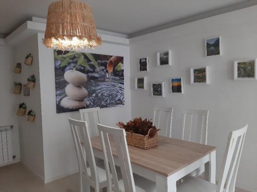 a dining room with a table and chairs and a chandelier at Férias de Sonho in Arcos de Valdevez