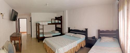 Ένα ή περισσότερα κρεβάτια σε δωμάτιο στο Hotel Campestre UMPALÁ