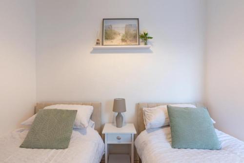two beds sitting next to each other in a bedroom at Spacious Two Bed loft Apartment in Birchanger