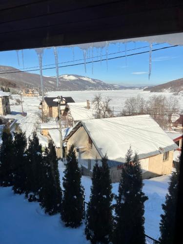 a house with a snow covered roof with trees at Mount House Mavrovo in Mavrovo