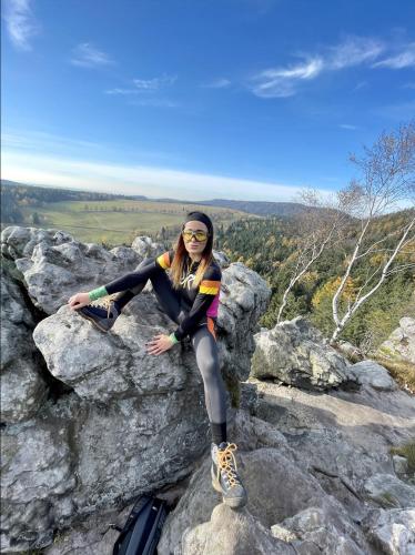 a woman sitting on top of a rock at Willa Spa Scaliano in Kudowa-Zdrój
