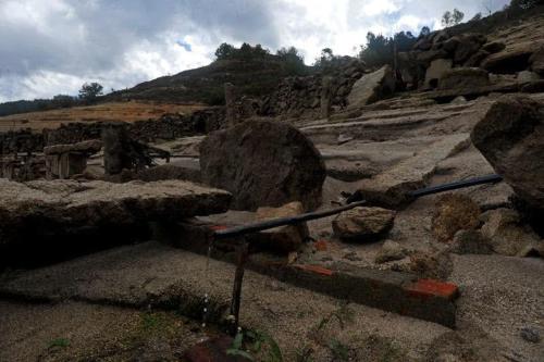 a group of rocks and a bench on a mountain at Secondary home in Lobios