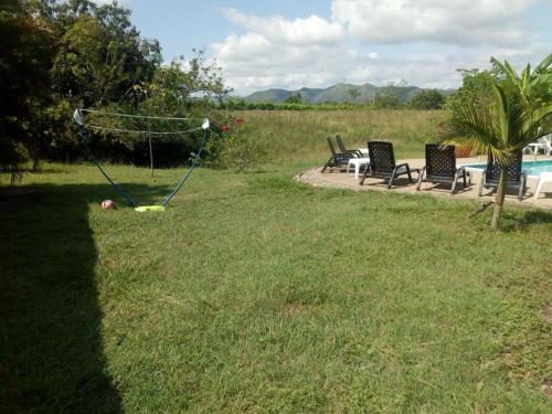 a yard with a swing set in the grass at Casa los Almendros in Guamo