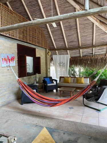 a hammock in a living room of a house at Casa los Almendros in Guamo